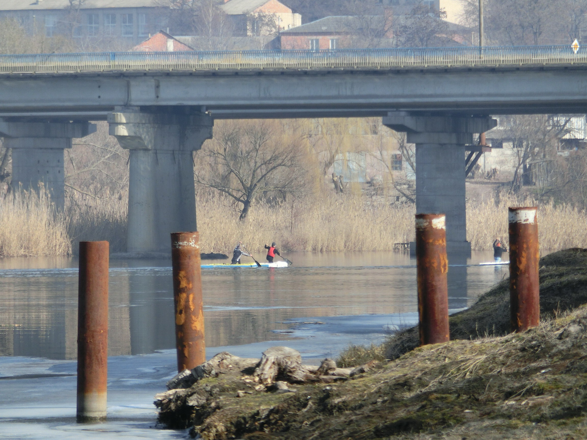 Spring. Kayaks under bridge